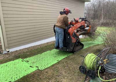 man using motorized equipment on green slats